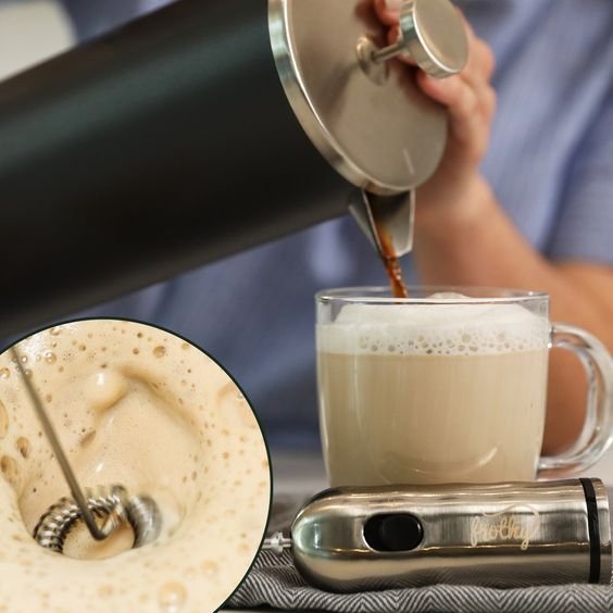 Silver cordless handheld milk frother with whisk head and storage sleeve