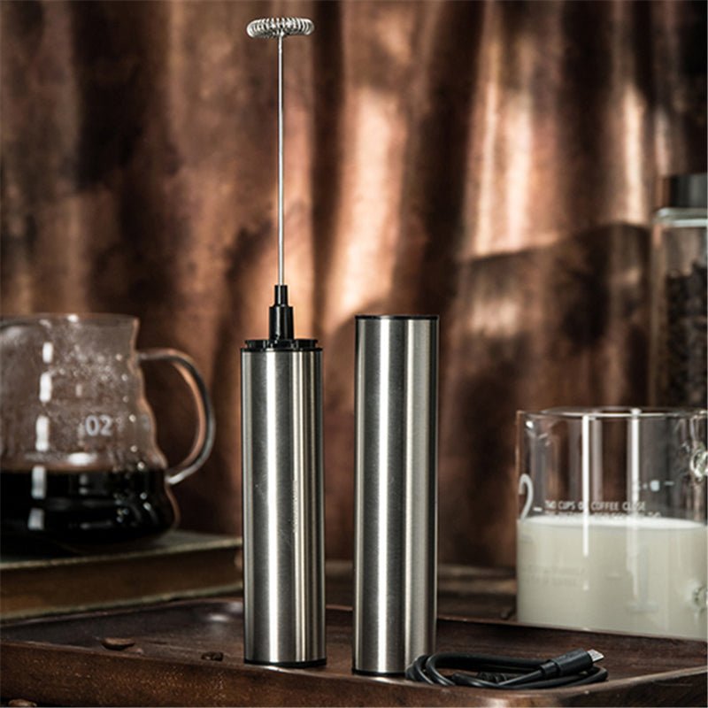 Silver cordless handheld milk frother with whisk head and storage sleeve