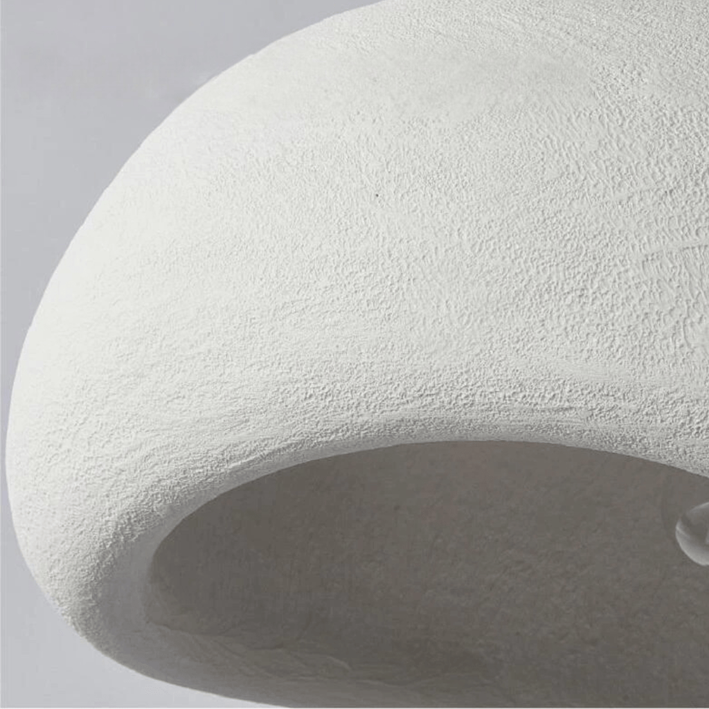 Curved dome pendant light with visible bulb suspended in a modern living room