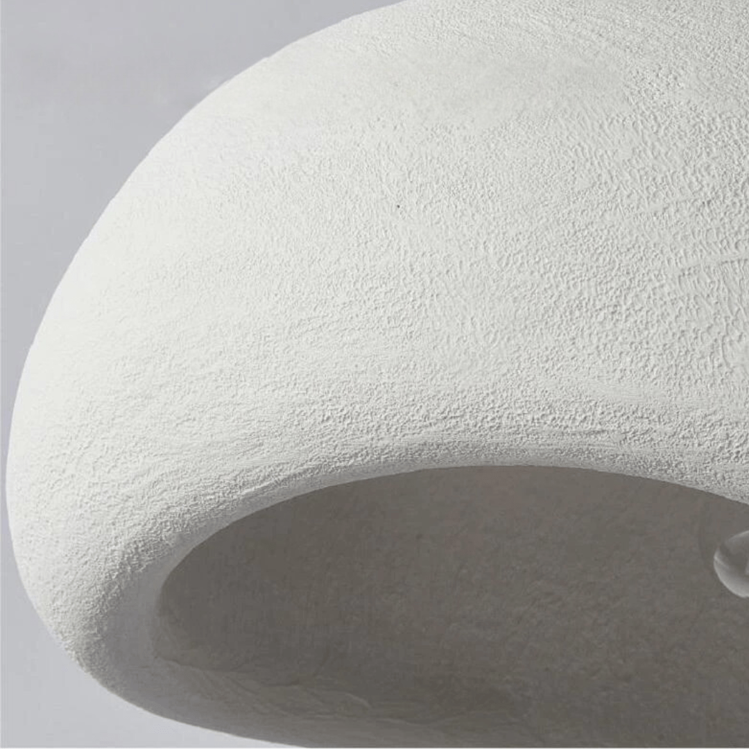 Curved dome pendant light with visible bulb suspended in a modern living room