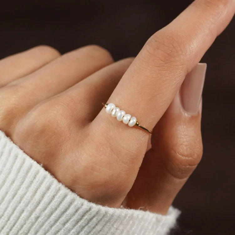 Gold-tone ring with a row of white pearl details