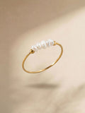 Gold-tone ring with a row of white pearl details