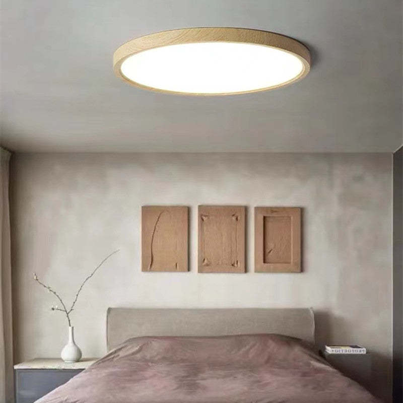Round slim ceiling light with a natural wood-effect ring and white diffuser