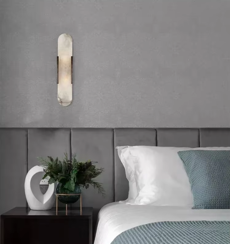Vertical LED wall sconce with a light marble panel and contrasting side rails