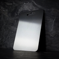 Silver titanium cutting board with brushed surface and integrated handle opening