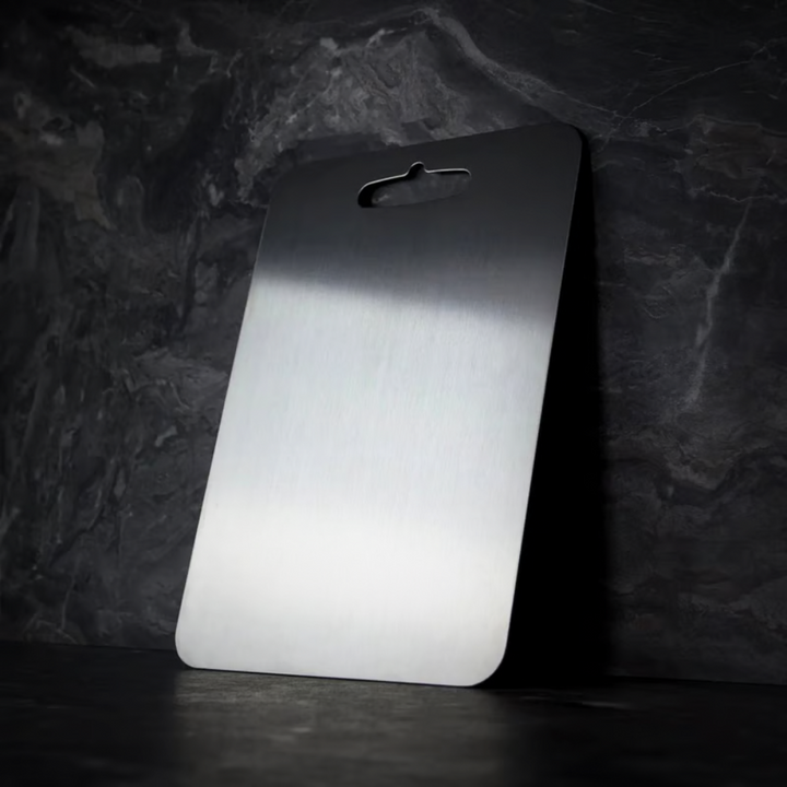 Silver titanium cutting board with brushed surface and integrated handle opening