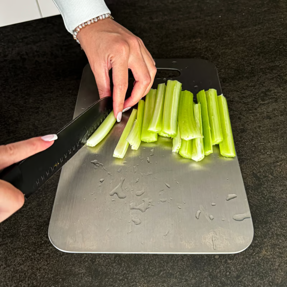 Silver titanium cutting board with brushed surface and integrated handle opening