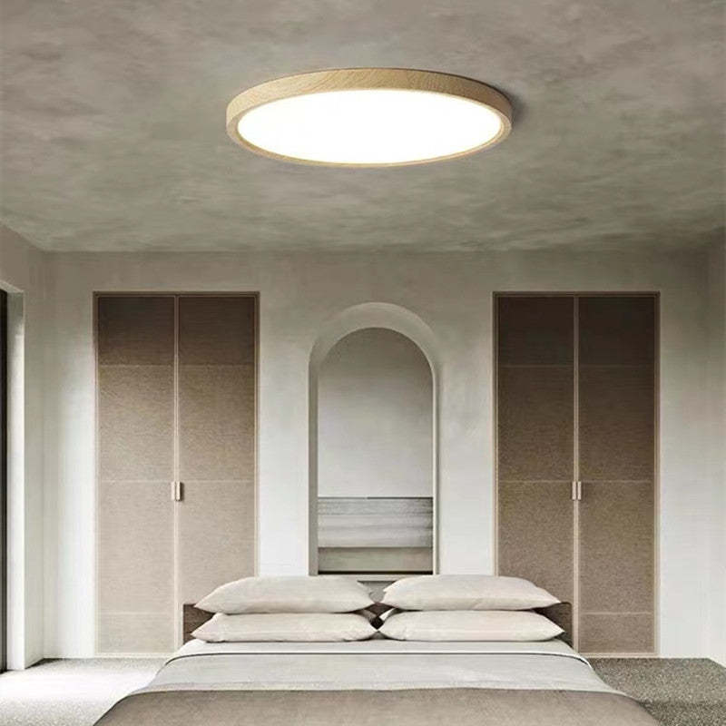 Round slim ceiling light with a natural wood-effect ring and white diffuser