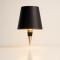 Bottle style table lamp with tapered shade and pointed decorative base