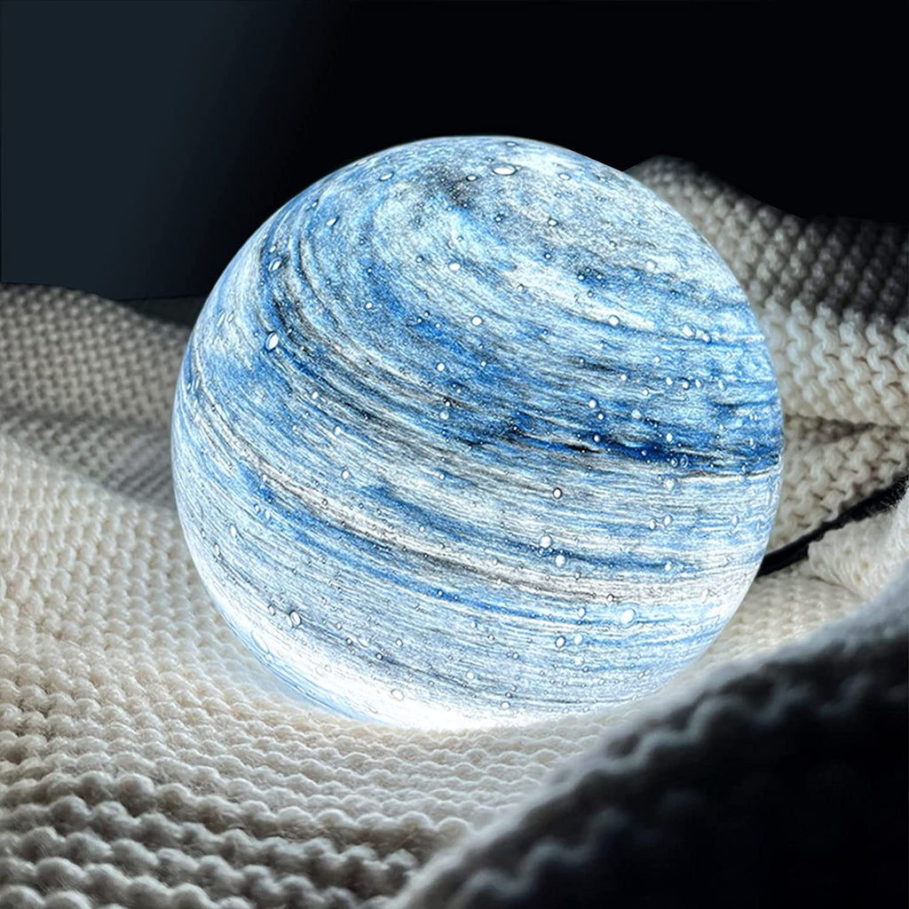 Spherical glass moon table lamp with swirling cosmic detailing