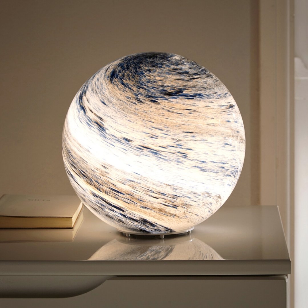 Spherical glass moon table lamp with swirling cosmic detailing