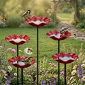 Red flower-shaped bird bath bowl on a black garden stake
