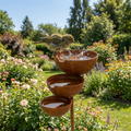 Vintage brown three-tier bird bath with three bowl basins on a garden stake