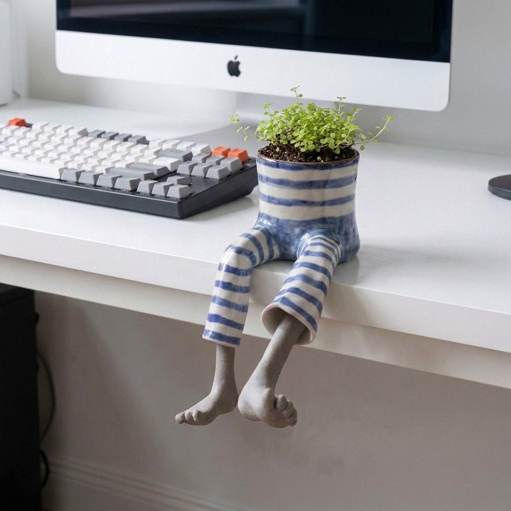 Decorative boot-shaped garden planter with sculpted legs