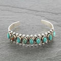Silver-tone open cuff bracelet with turquoise-toned decorative stones