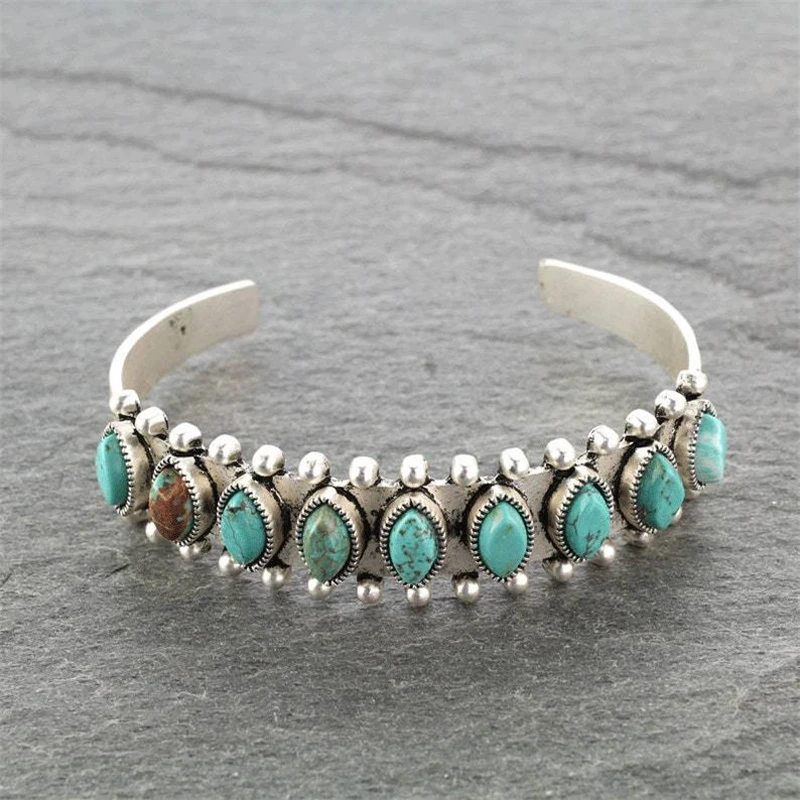 Silver-tone open cuff bracelet with turquoise-toned decorative stones