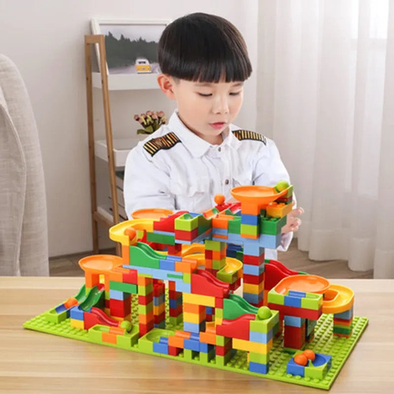 Colourful marble run construction set with interlocking blocks, ramps and tracks