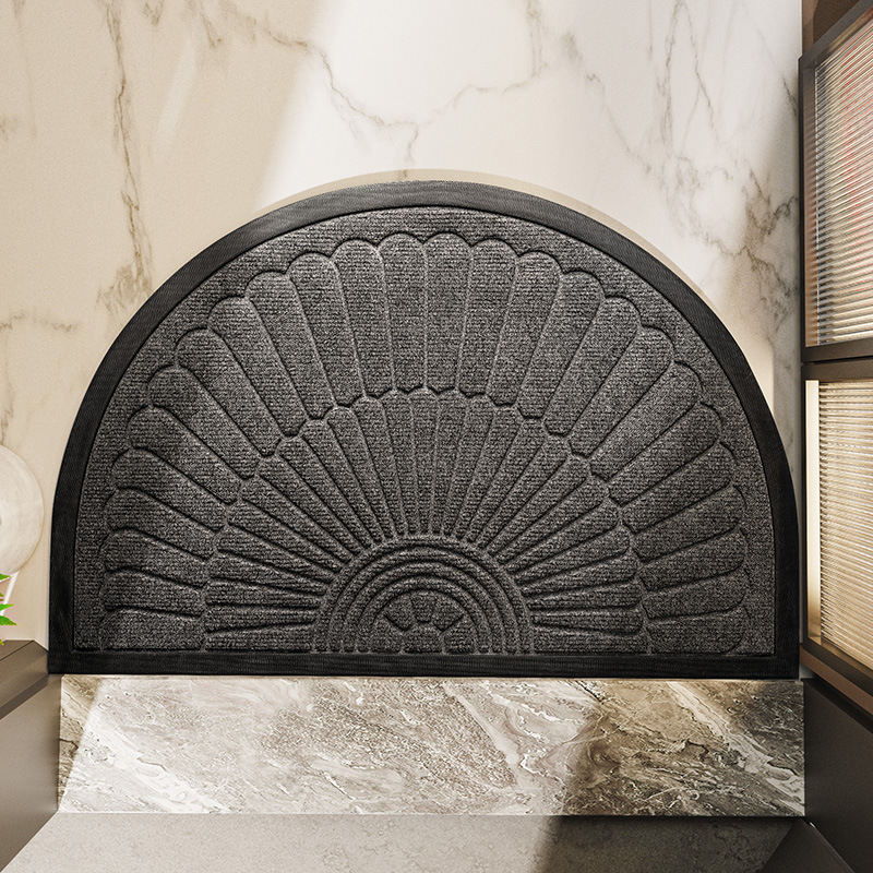 Semi-circular textured rubber door mat with raised fan pattern