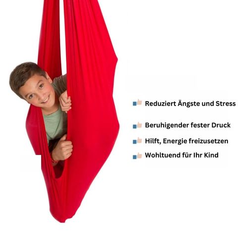 Child sitting in a fabric indoor hanging pod swing