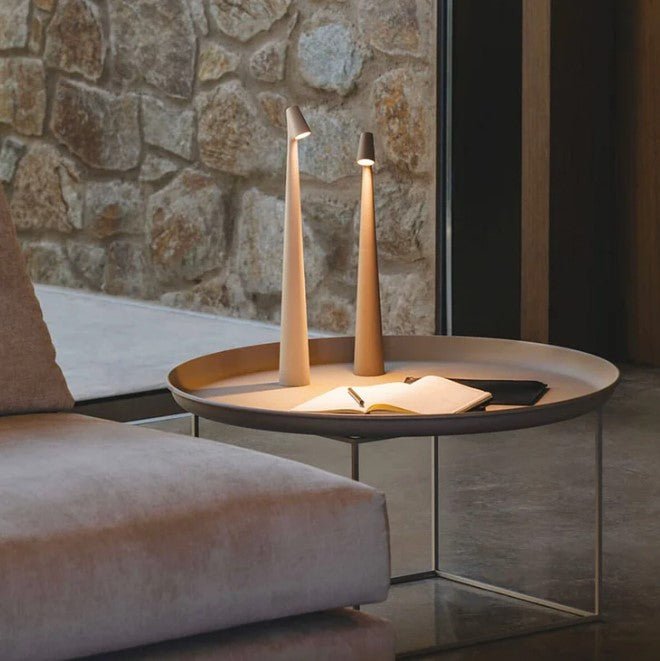 Cordless LED table lamp with a tall tapered body and angled light head