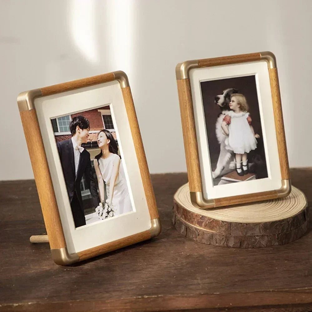 Tabletop photo frame with wood-effect border and brass-effect corner details