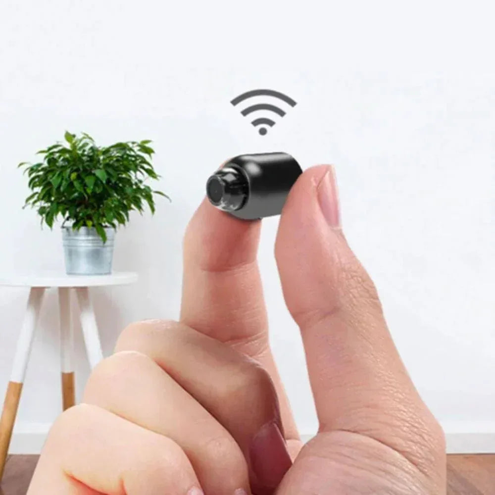 Compact black mini camera with front lens and integrated stand
