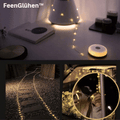 Warm white LED string lights arranged around a garden path and decorative display