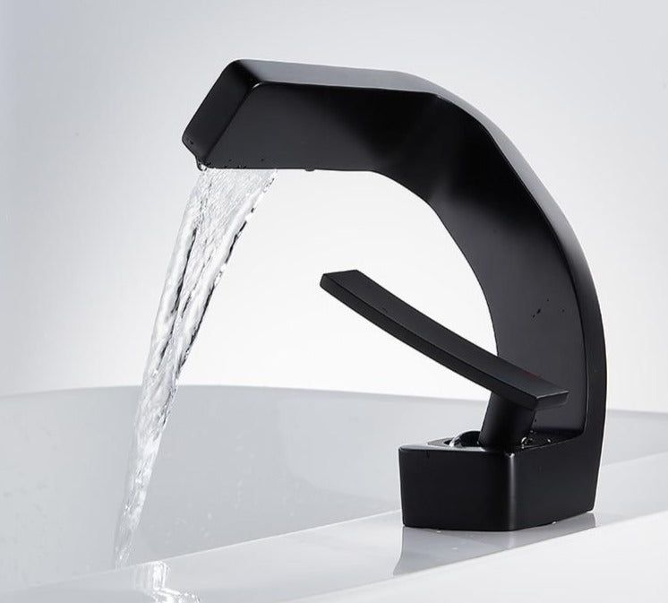 Curved bathroom basin faucet with waterfall-style spout and single lever