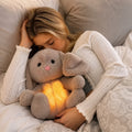 Gray bunny stuffed animal with long ears and glowing yellow belly