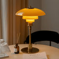 Layered LED table lamp with dome shade and circular metallic base