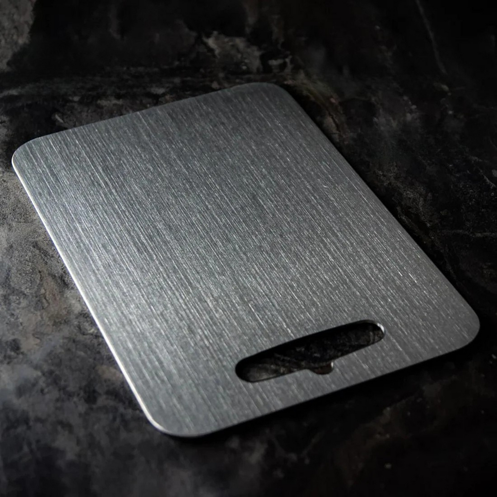 Silver titanium cutting board with integrated handle opening