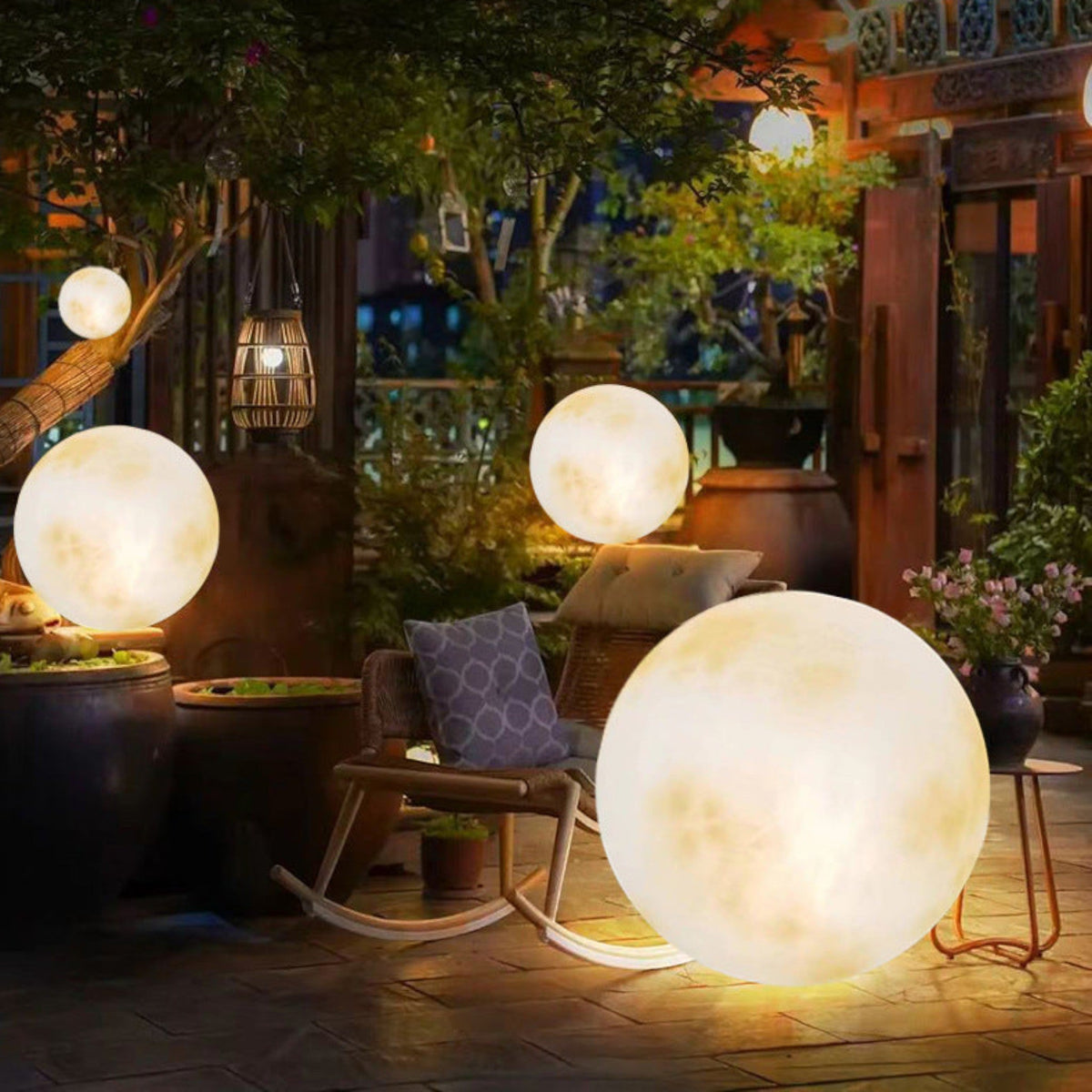 Illuminated yellow moon sphere garden lamp with mottled surface