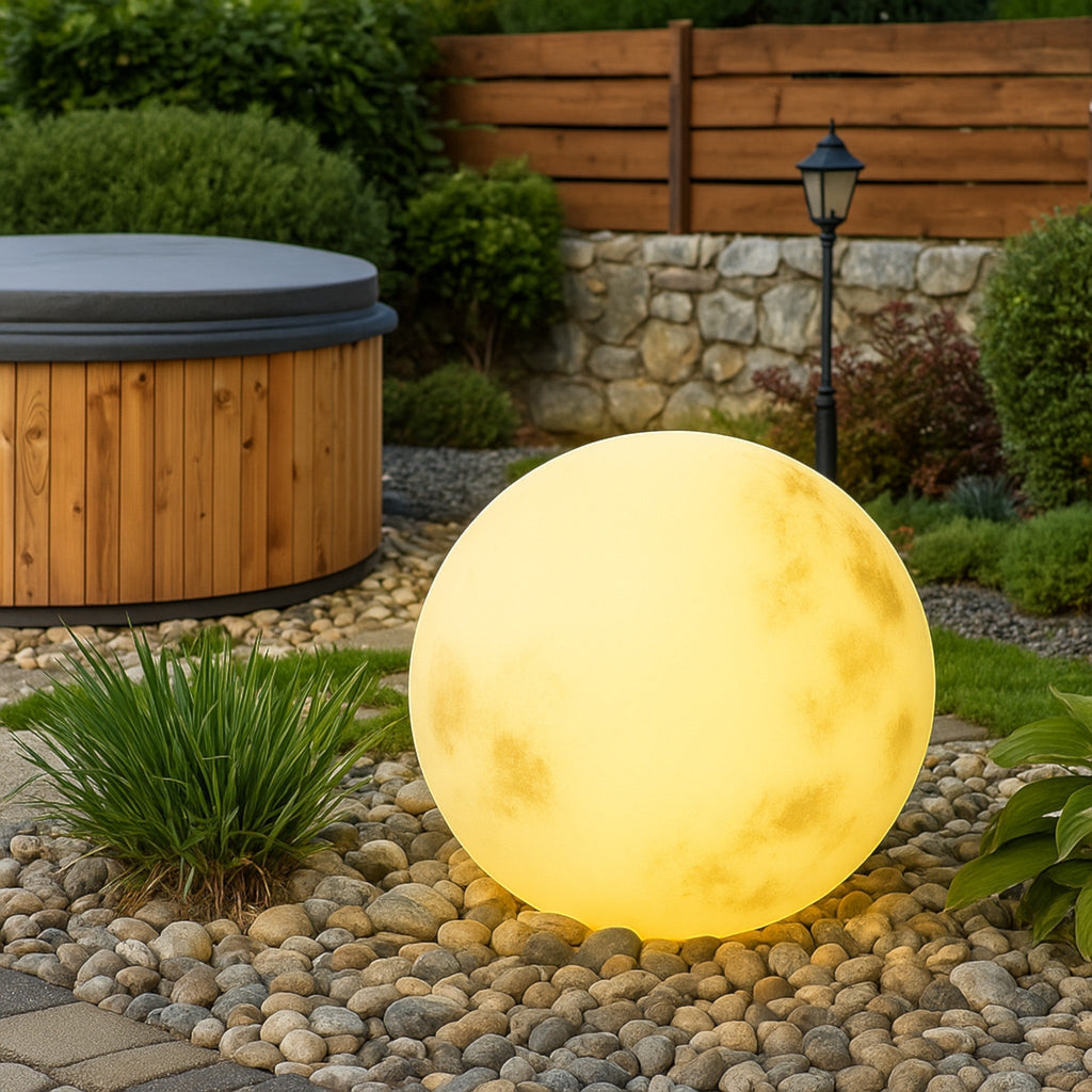 Illuminated yellow moon sphere garden lamp with mottled surface